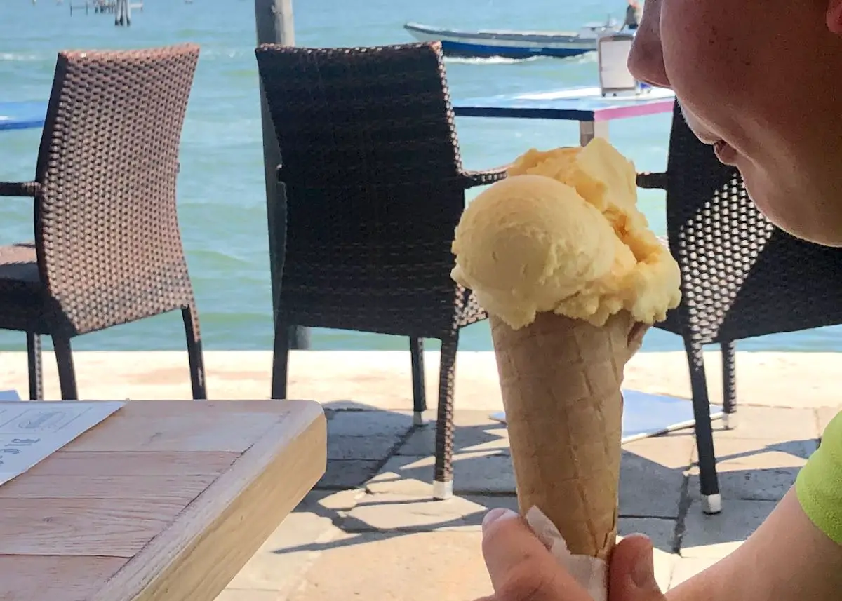 Ein Kind isst Eis in Venedig