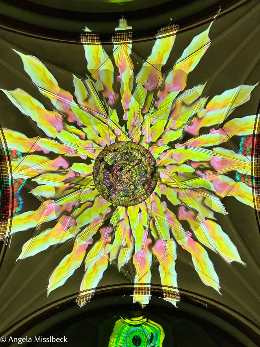 Eine gelbe Aster als Lichtprojektion bei einer immersiven Show an der Decke der Passionskirche Berlin